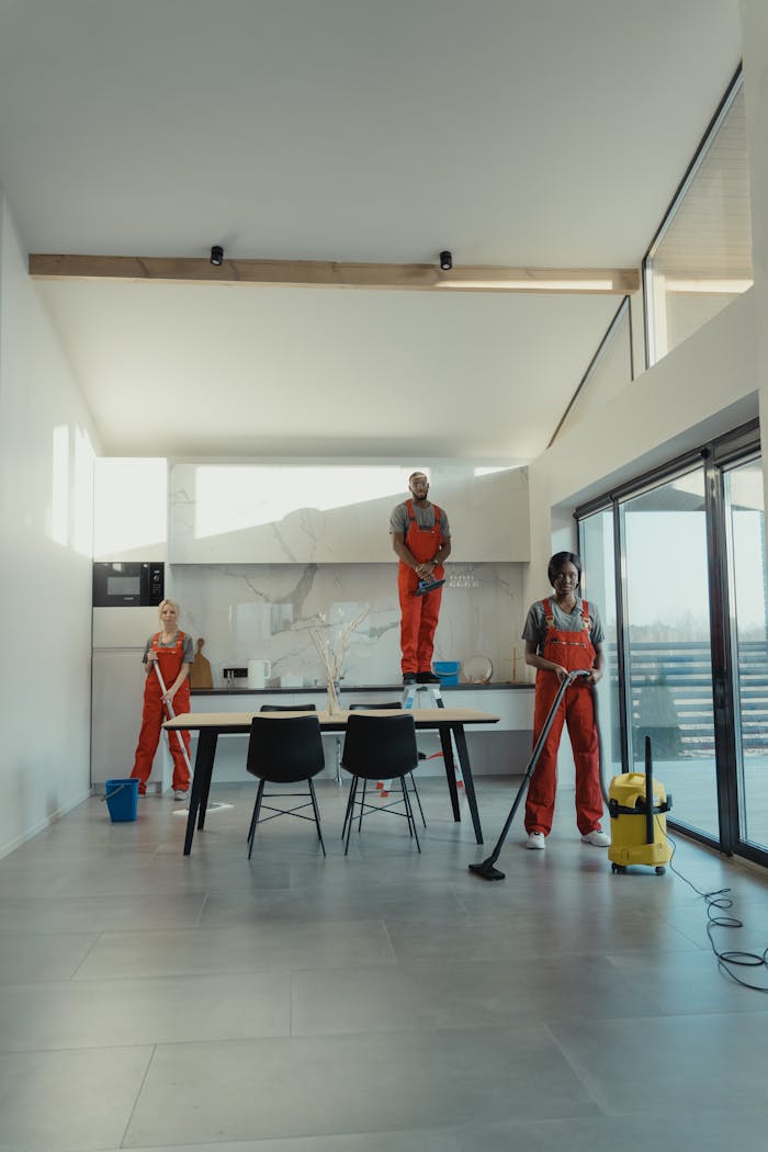 hero-img-01 Team of professional cleaners working in a spacious, modern indoor setting.